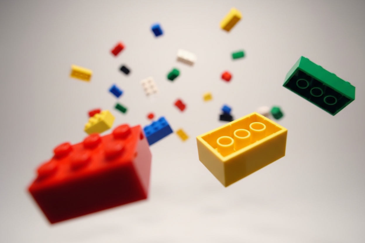Assorted colorful building blocks scattered on a black background